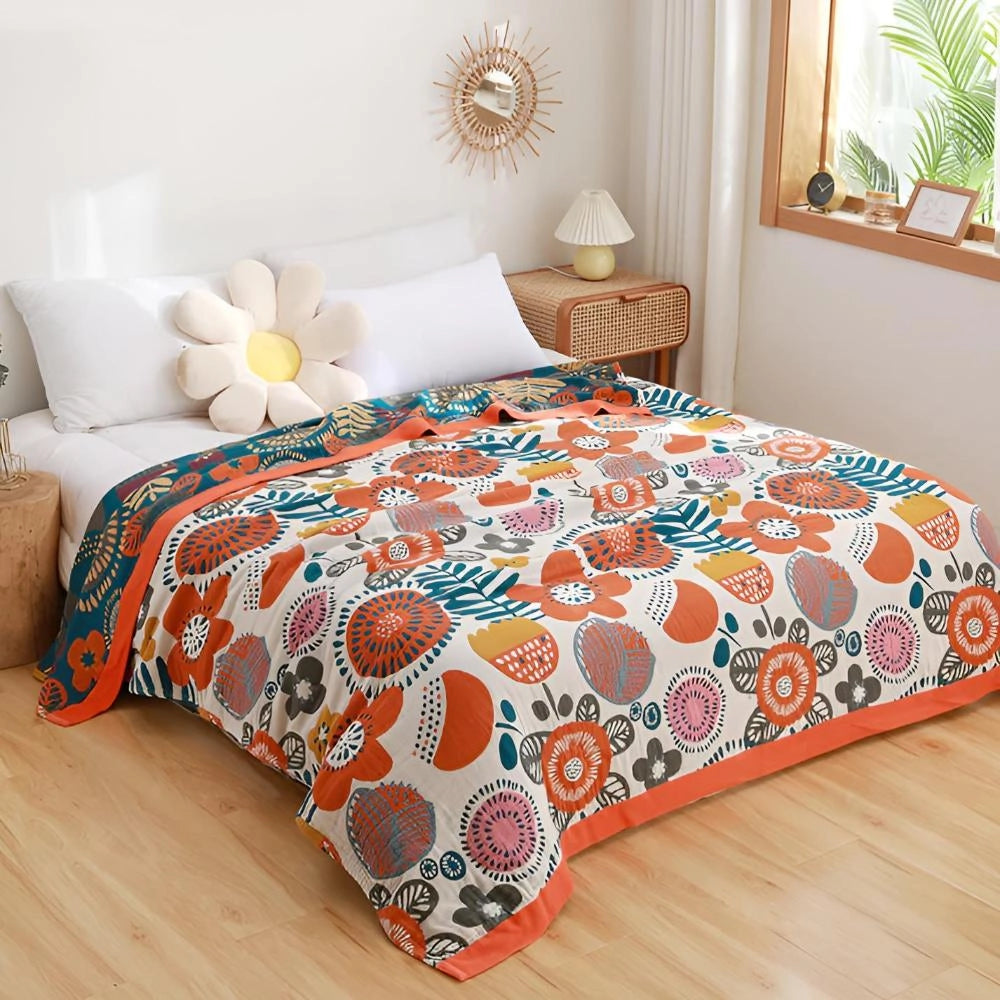 Bohemian Floral Comforter Set on a queen-sized bed, featuring an ethnic print design with vibrant orange and floral patterns, set in a cozy bedroom with wooden flooring and plant accents.