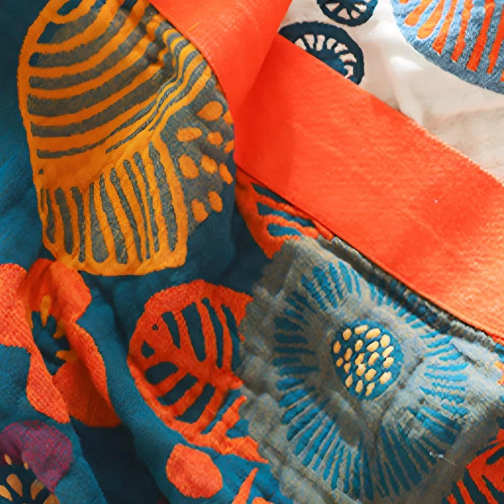 Bohemian floral comforter set in queen size featuring an ethnic print design with vibrant orange and carmine patterns, accented by electric blue details, displayed on a bedding ensemble.