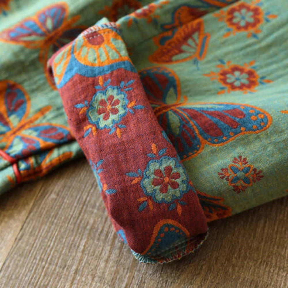 Bohemian floral print women's pants in turquoise with a paisley summer design, showcasing an intricate pattern with vibrant electric blue and magenta hues.