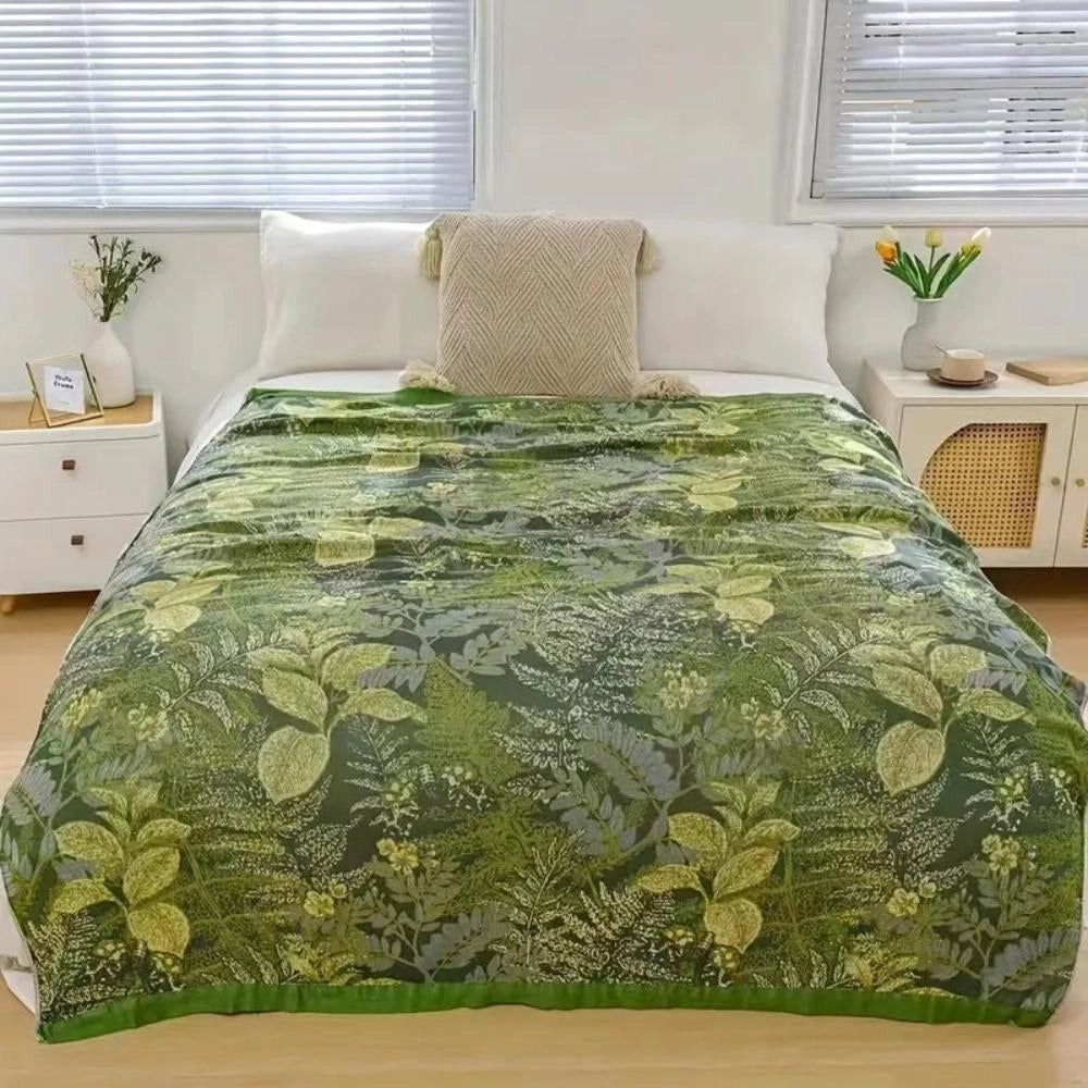 Botanical Green Leaf Duvet Cover in a tropical jungle design, displayed on a bed in a room with wooden flooring and shaded windows.