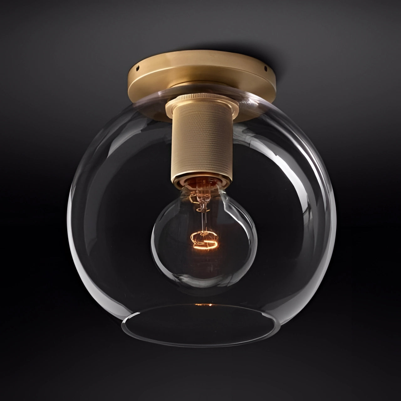 Vintage Industrial Brass Ceiling Light with Globe Design and Edison Bulb, emitting warm light through glass shade.