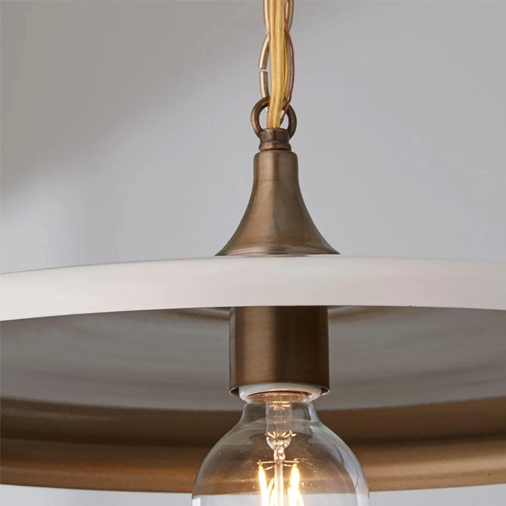 Bronze minimalist circular metal pendant light with adjustable chain, featuring a sleek design and a glass shade, suitable for ceiling mounting.