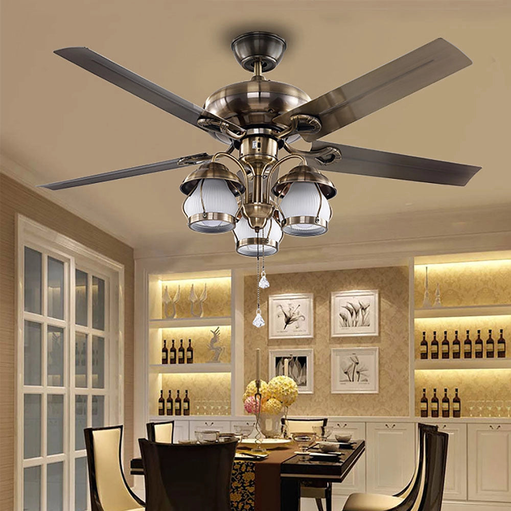 Brushed nickel 5-blade ceiling fan with lights and pull chain, installed indoors, featuring sleek wooden blades and integrated lighting fixtures.