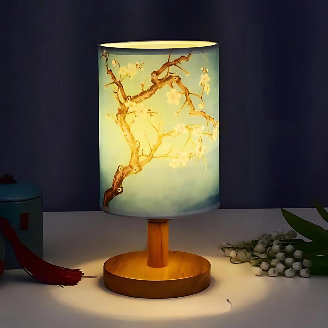 Cherry Blossom Table Lamp featuring a delicate sakura branch design, elegantly illuminated on a wooden base, creating a cozy and artistic ambiance for any room.