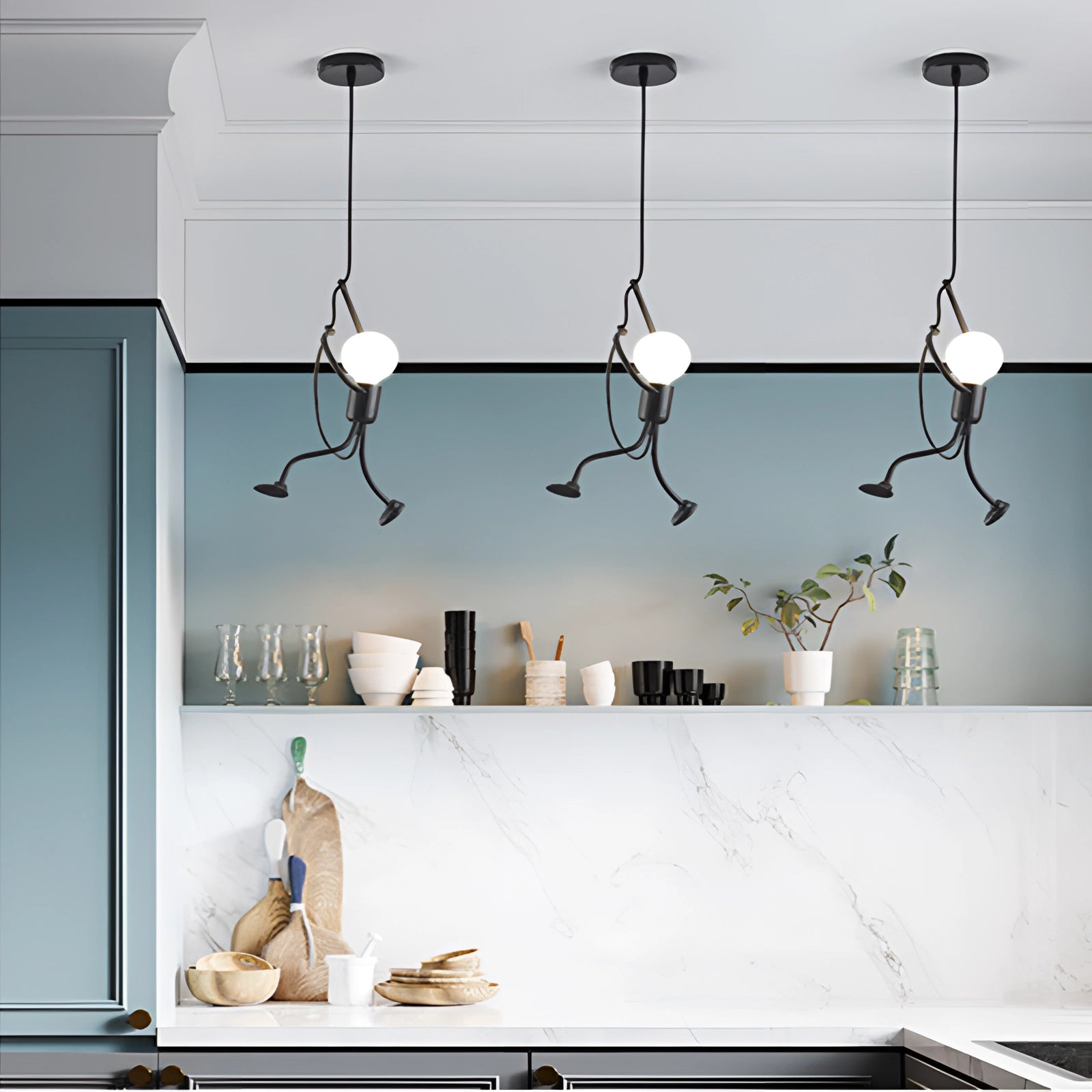 Chic modern marble pendant lights hanging over a stylish kitchen island, showcasing adjustable overhead lighting with a sleek white finish, complementing the contemporary interior design with minimalistic decor including wall art and a potted plant.