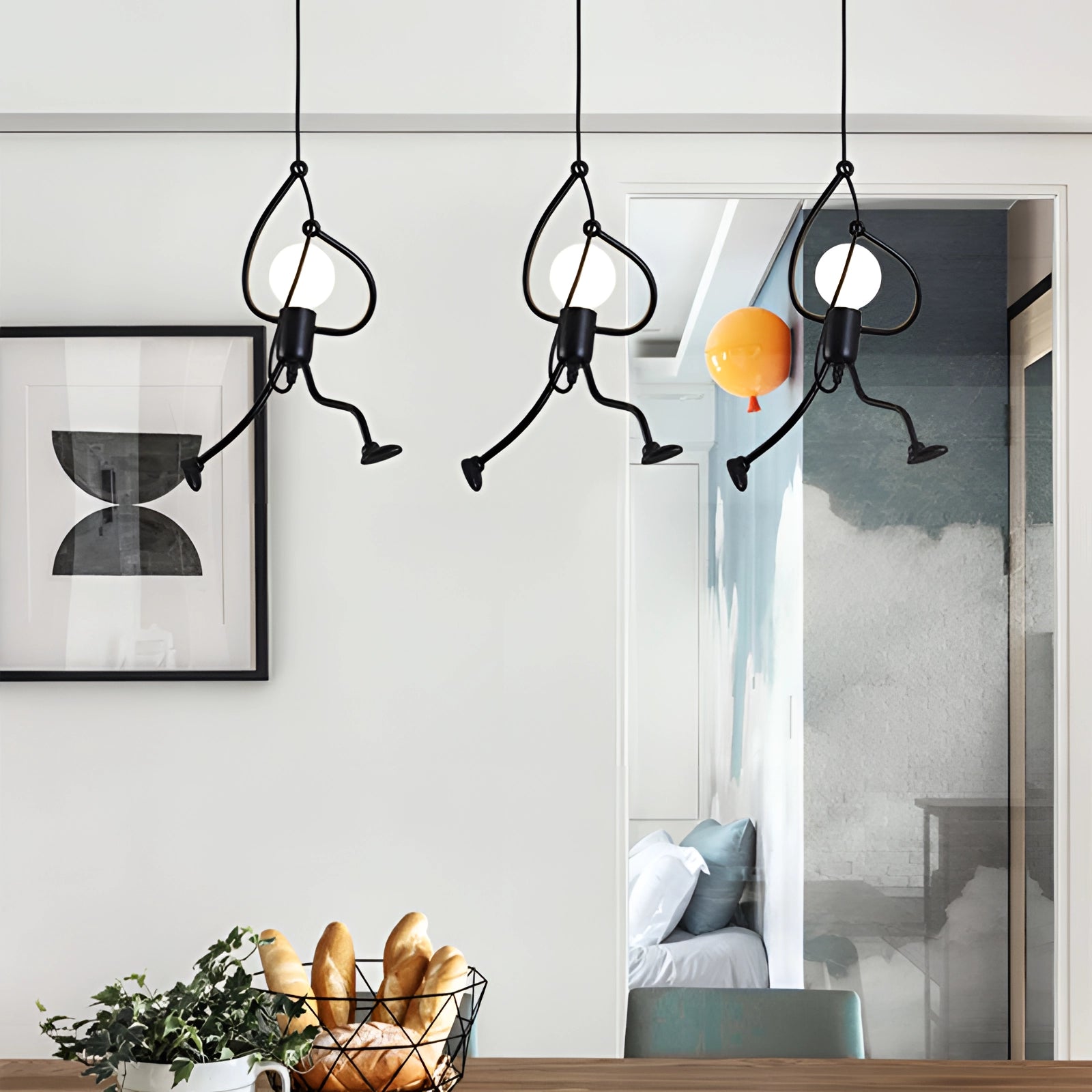 Modern white marble pendant lights hanging over a kitchen table with sleek, adjustable cords and contemporary interior design.