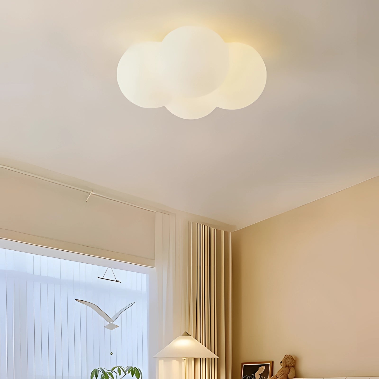 Cloud-shaped LED ceiling light fixture with a modern minimalist design, emitting a soft white light. The fixture is mounted on a wooden ceiling in a stylishly painted interior, enhancing ambient lighting and complementing the room's decor.
