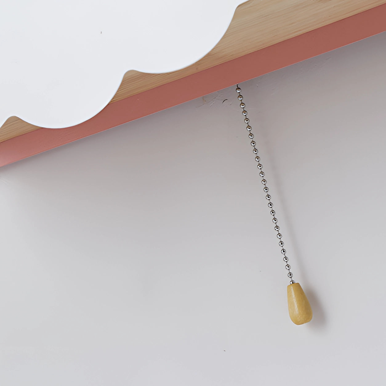 Cloud-shaped LED wall lamp designed for children's rooms, featuring a wooden base with a natural finish and a whimsical star design. The lamp's body is crafted to resemble a cloud, providing a soft, comforting glow ideal for bedtime.