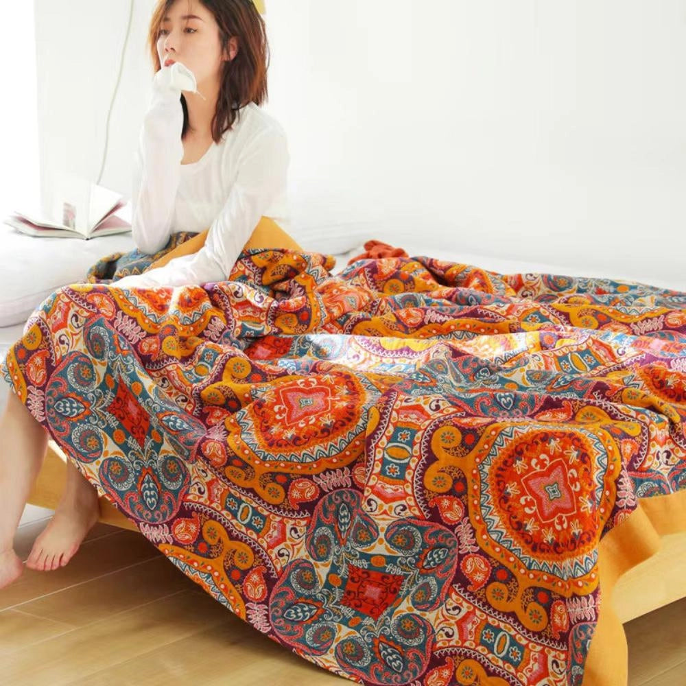 Colorful Boho Paisley Quilt featuring a vibrant vintage patchwork design, showcasing intricate paisley patterns in a luxurious and comfortable textile, predominantly with orange hues.