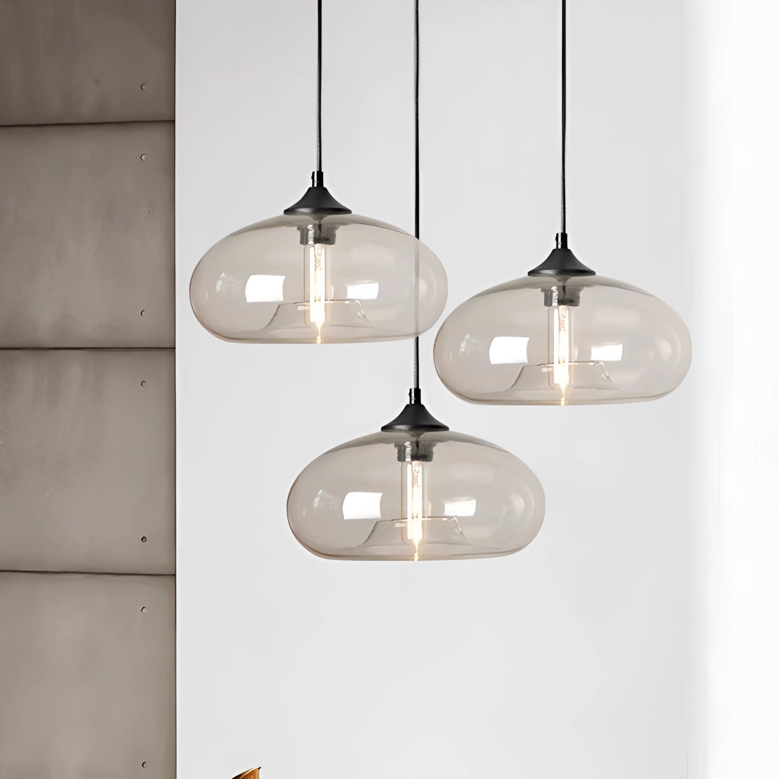 Modern mid-century ceiling fixtures featuring colorful glass pendant lights with a combination of wood and metal elements, suspended and illuminating the space with a warm, inviting glow.