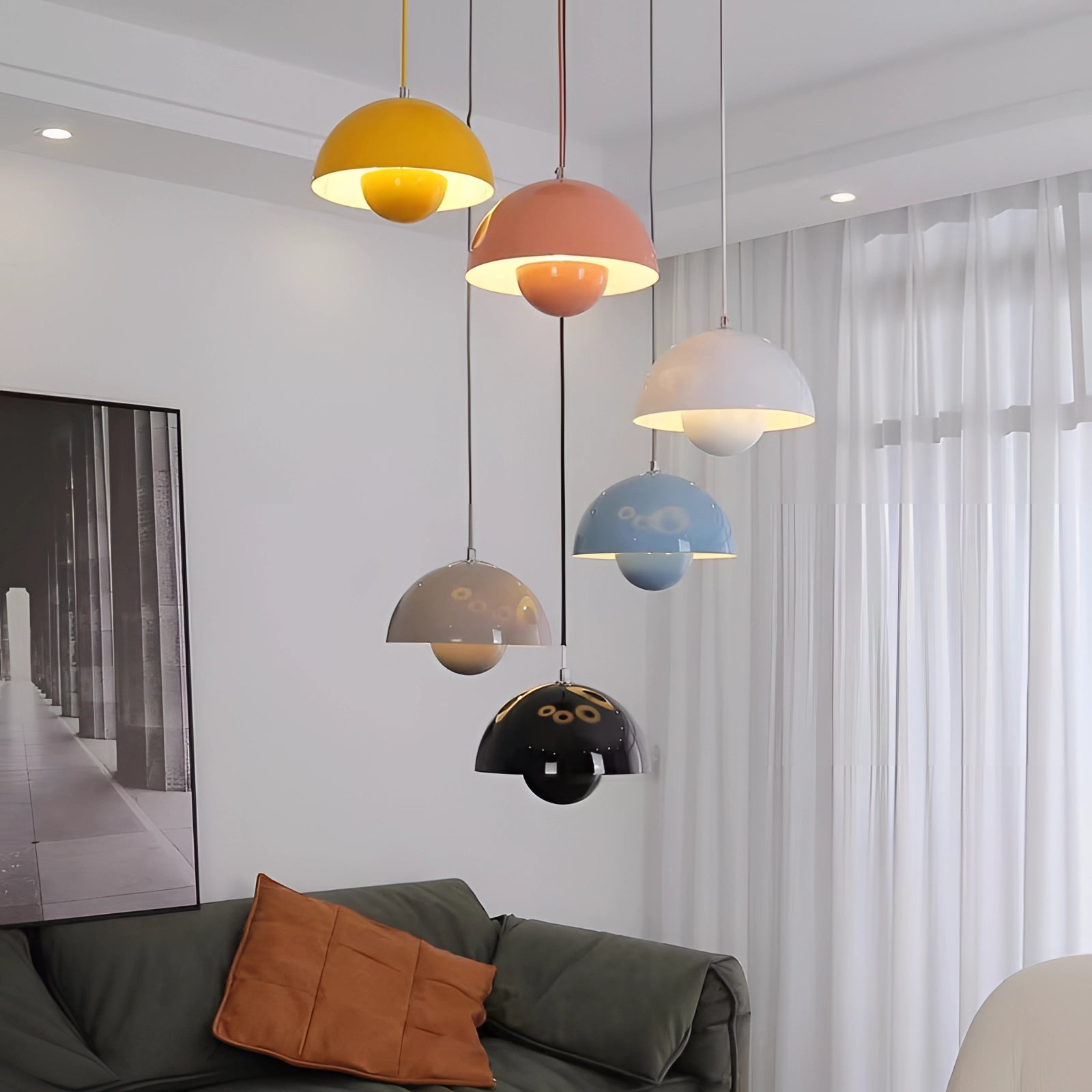 Modern dining room with colorful pendant lights, retro Scandinavian decor, wooden floor, and comfortable interior design elements.