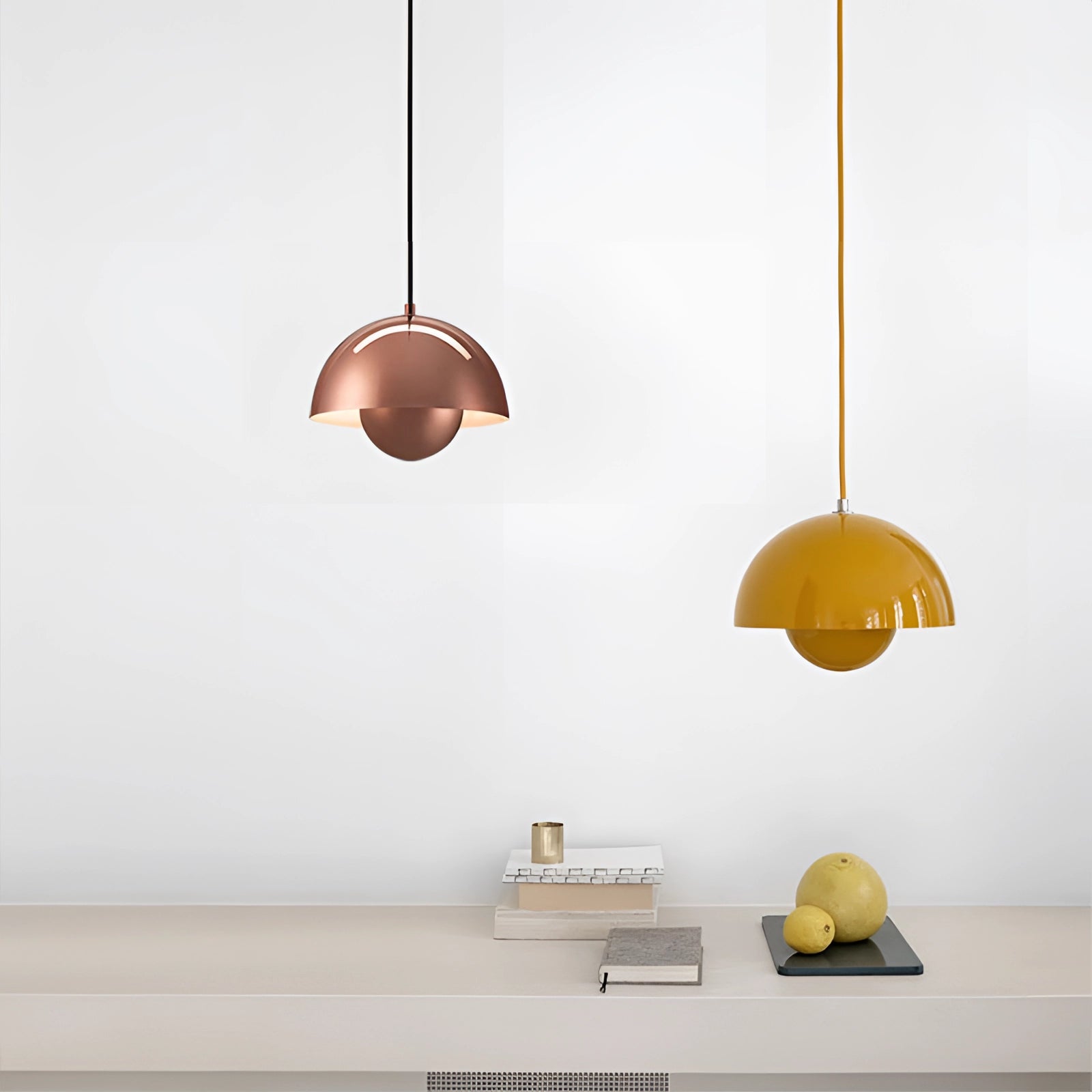Colorful pendant lights with orange and wooden elements, hanging from the ceiling in a modern dining room with retro and Scandinavian decor.