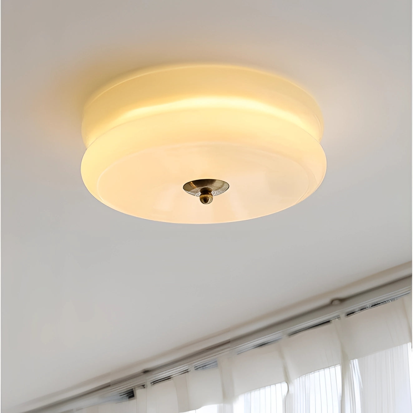 Round cream ceiling lamp with a modern frosted glass design, mounted on a wooden ceiling, suitable for home decor.