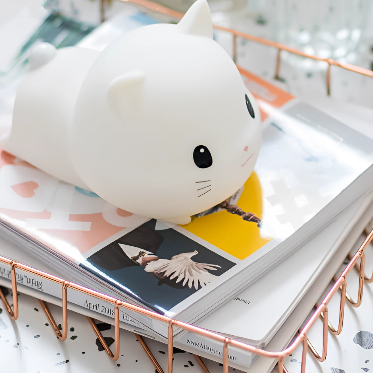 Cute cat-shaped LED nightlight made of soft silicone material, featuring a charming design suitable for kids. The lamp is primarily white, with a rechargeable function, resembling a playful kitty.