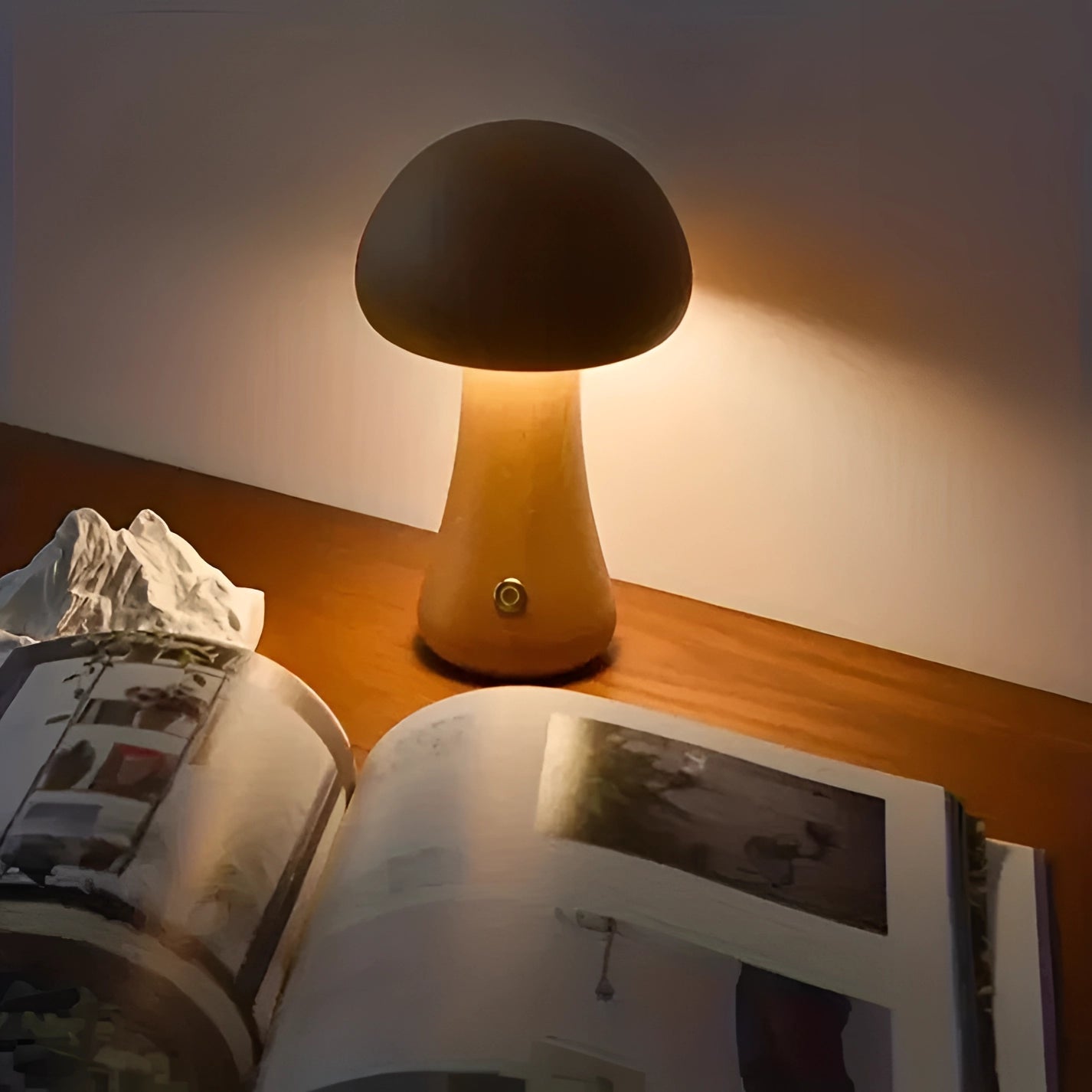 Designer mushroom lamp with a dimmable wooden base, showcasing a modern minimalist design, emitting ambient lighting on a table.
