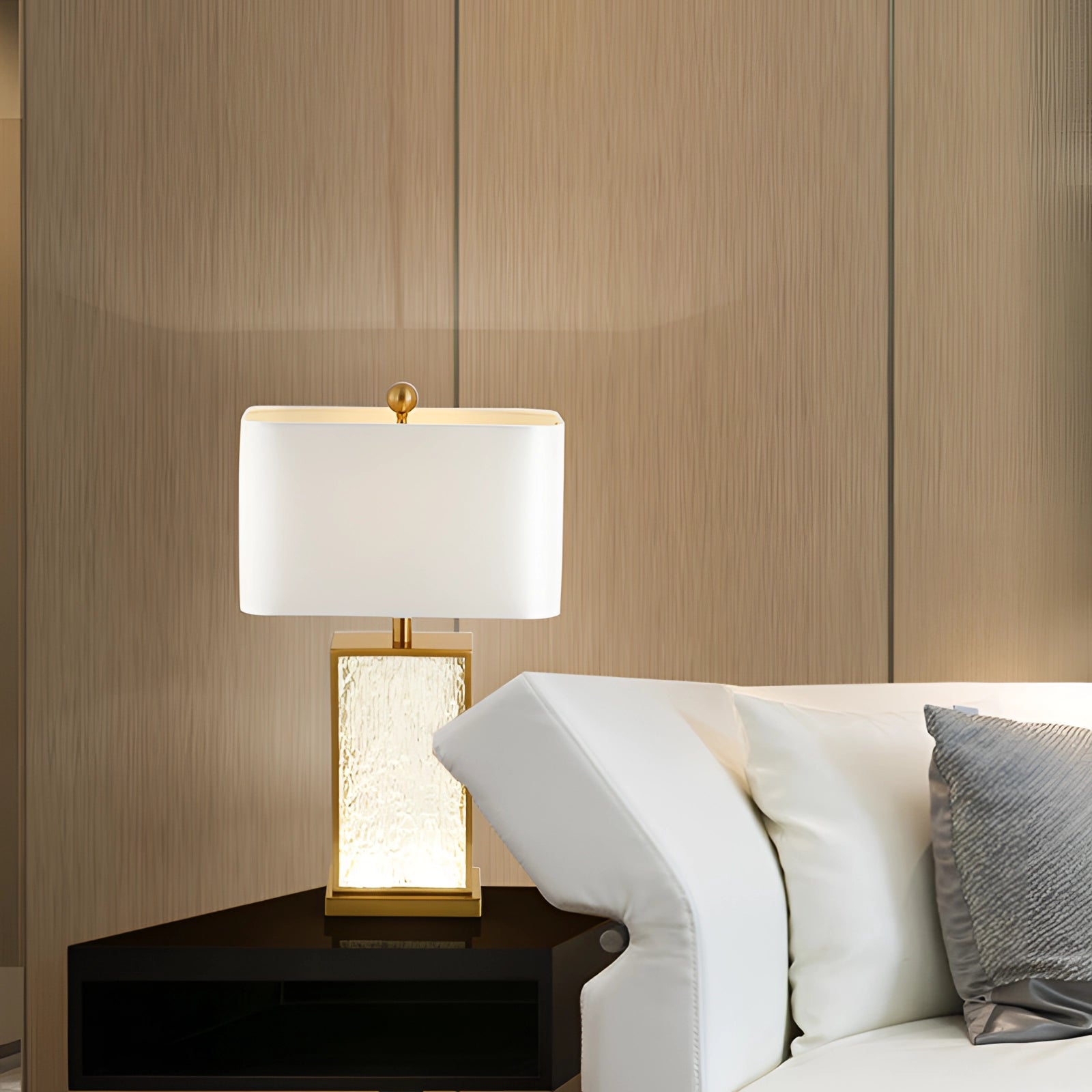 Elegant designer table lamp with a luxury gold finish and a white shade, positioned on a wooden floor and enhancing modern interior decor.
