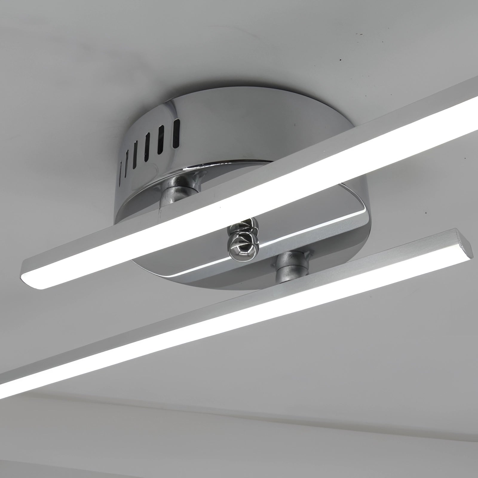 Modern minimalist dual-arm adjustable LED wall sconce featuring sleek lines and a contemporary design with a metallic finish, ideal for enhancing interior spaces with stylish and functional lighting.