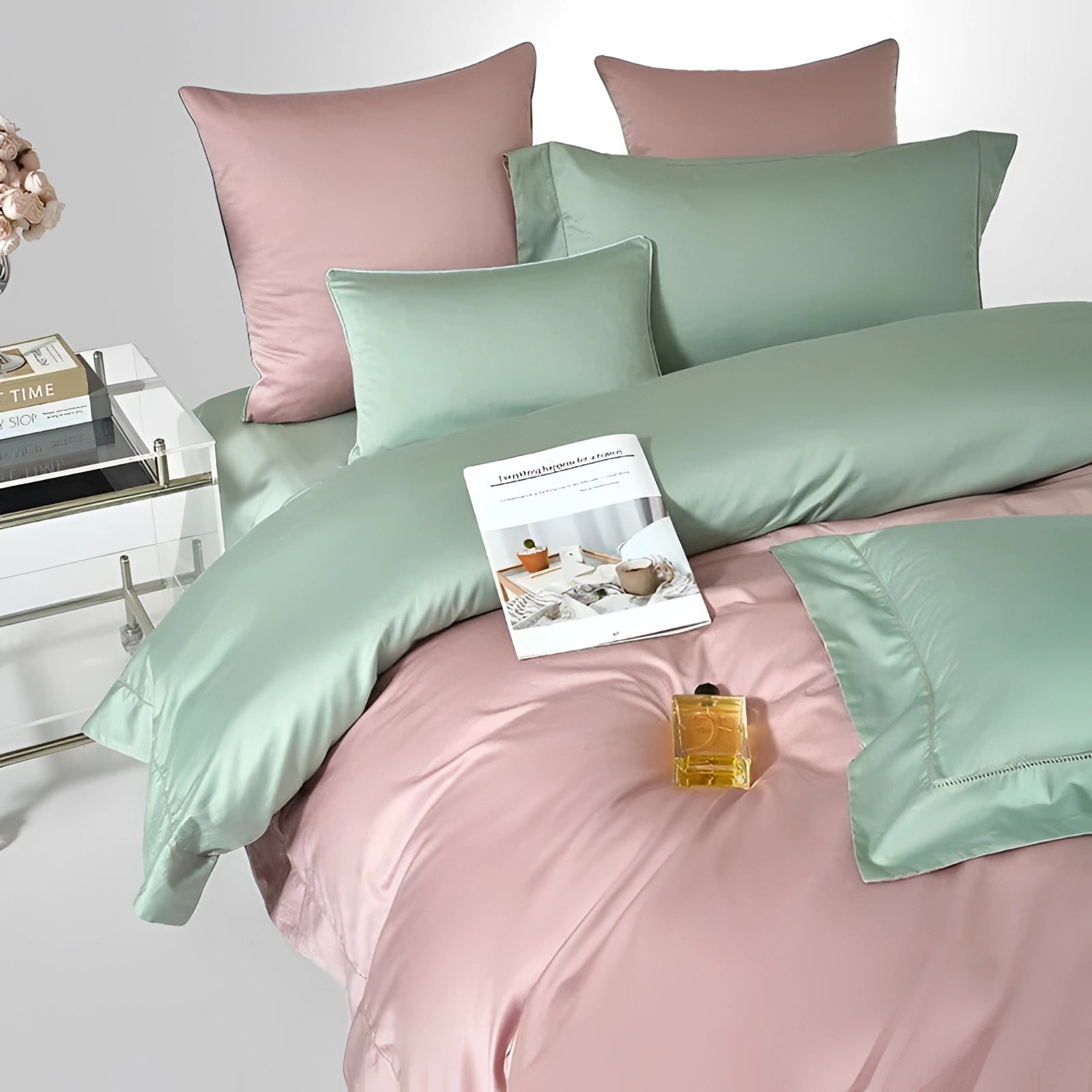 Luxurious dual-color Egyptian cotton duvet set in shades of pink and green, styled on a neatly arranged American king-size bed with plush pillows, set against an elegant interior design backdrop.