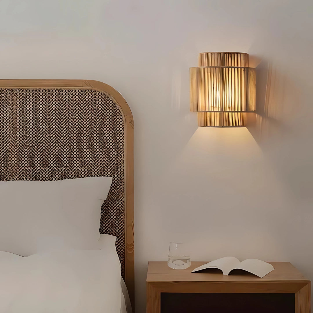 Eco-friendly bamboo wall lamp with a modern rattan design, mounted on an interior wall, providing warm and comfortable lighting.