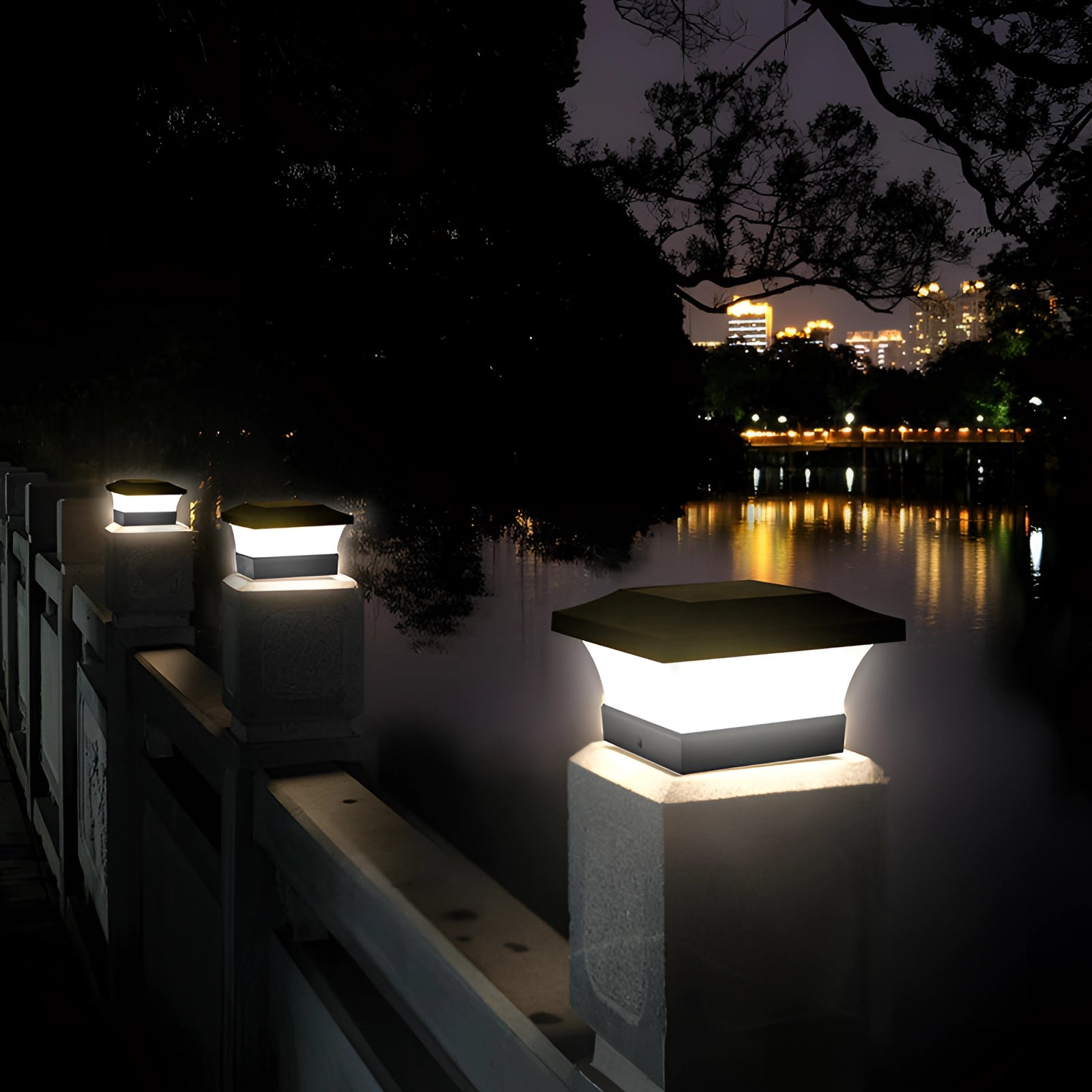 Eco-Friendly LED Solar Post Cap Light illuminating a garden at dusk with trees, a lake, and a city skyline in the background.