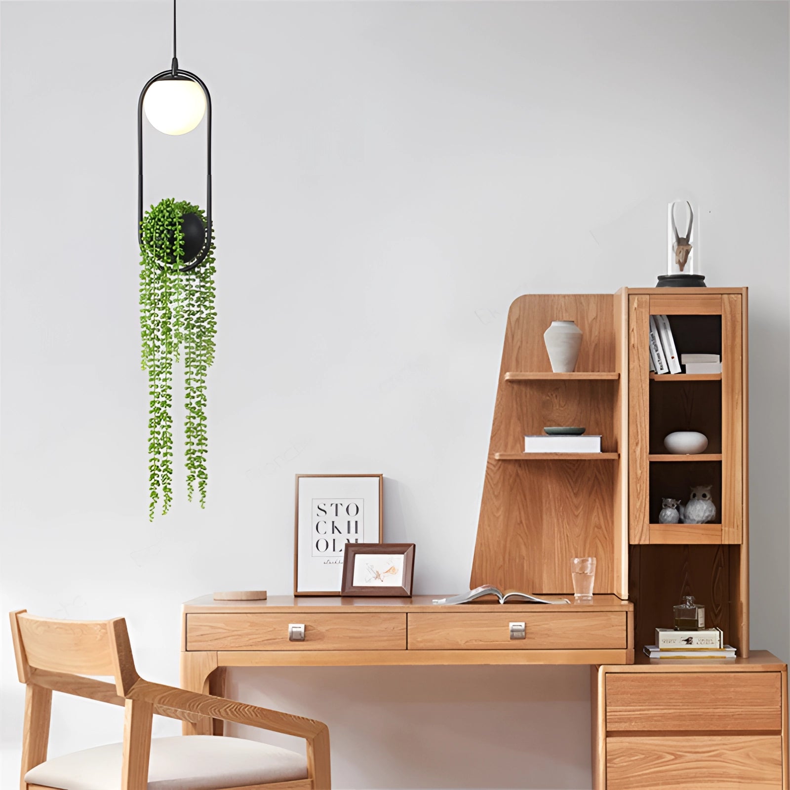 Eco-friendly Scandinavian plant pendant light fixture hanging above a modern wooden desk in a stylish interior setting.