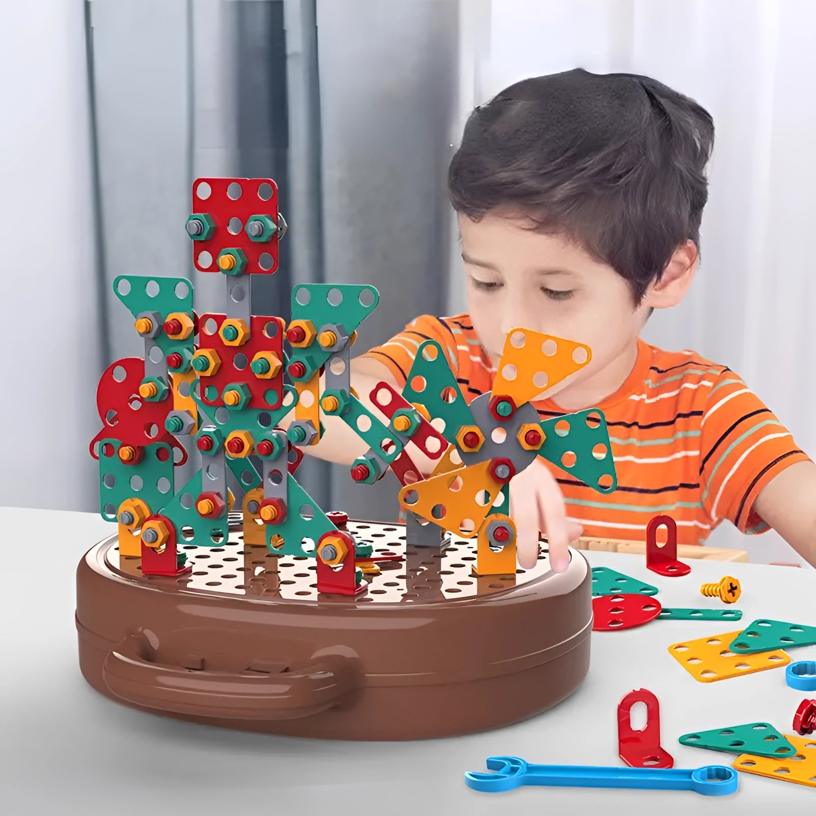 Electric drill toy set with various colorful plastic pieces, designed for children, displayed on a table. The set encourages fun and educational STEM construction activities for kids.