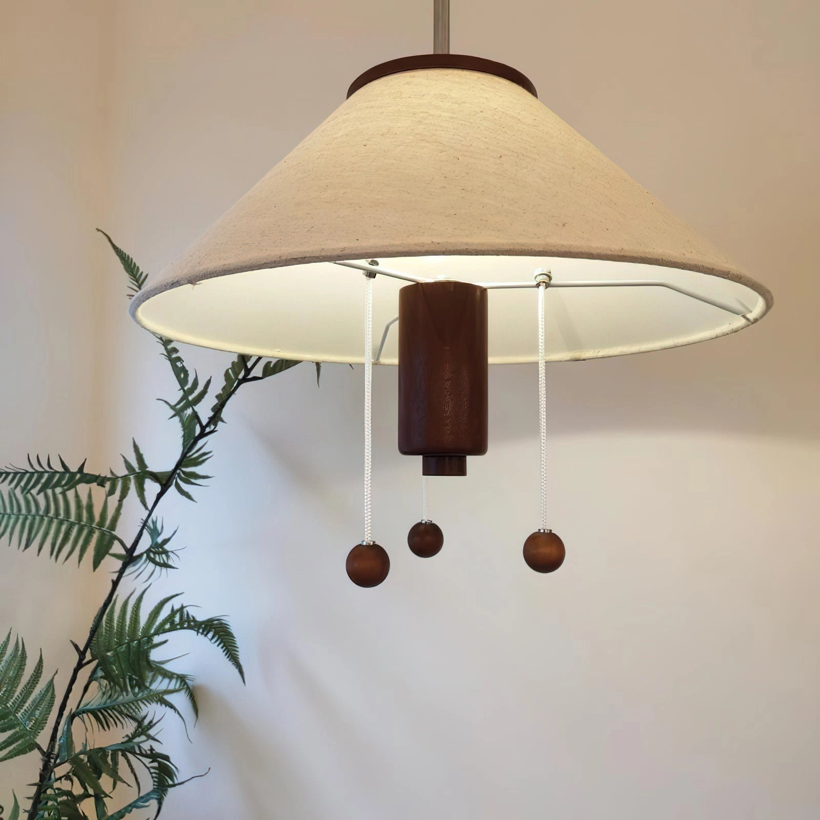 Elegant pendant lamp featuring a modern design with a rectangular wooden detail and a fabric shade, suitable for ceiling installation in a house.