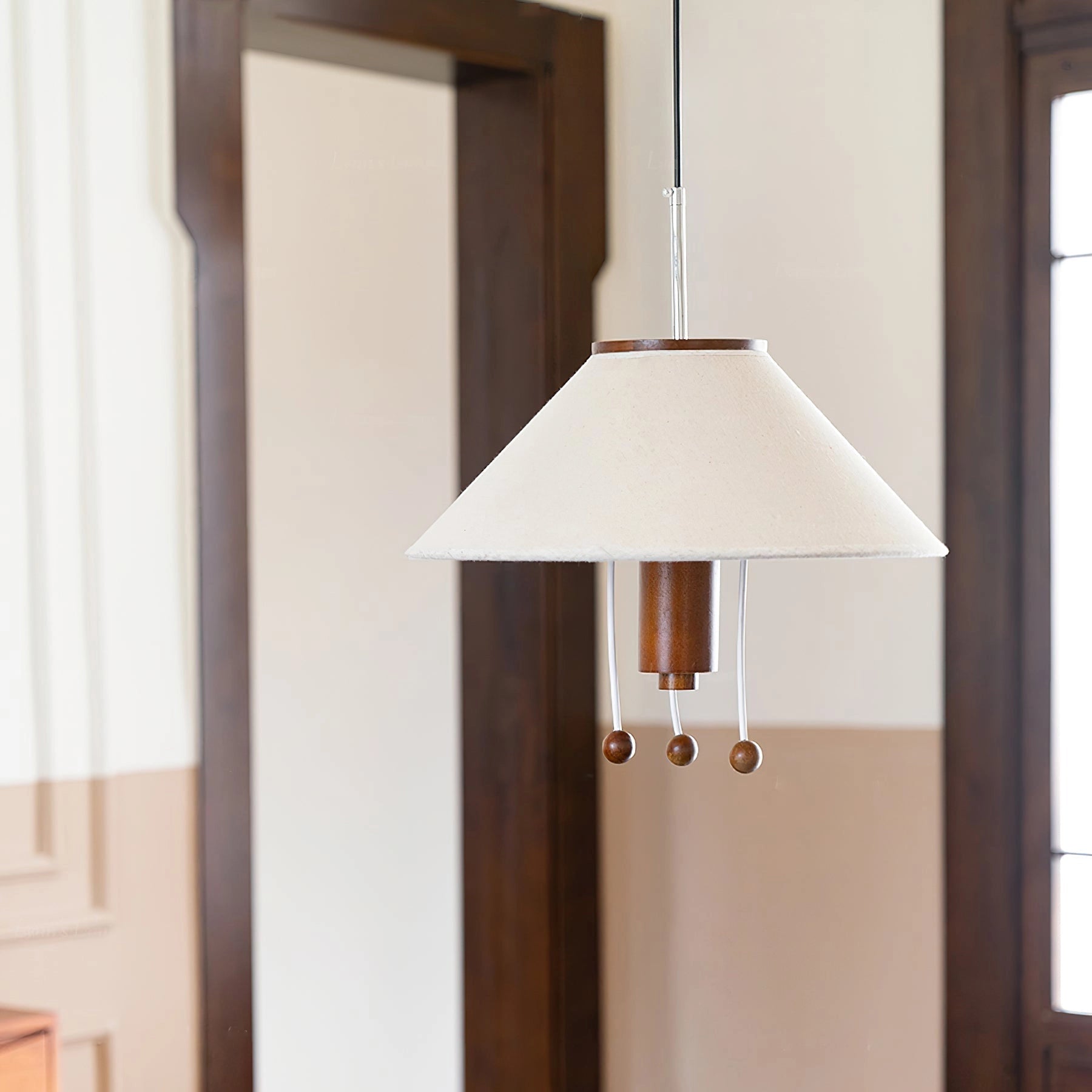 Elegant pendant lamp with modern wood detailing and a fabric shade, featuring a rectangular shape and hung from the ceiling.