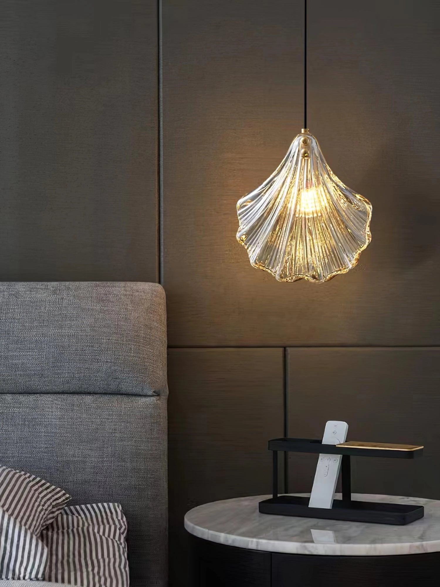 Elegant Petal Glass Pendant Light with a single head, featuring a modern LED floral chandelier design in a brass finish and clear glass, hanging in an interior setting.