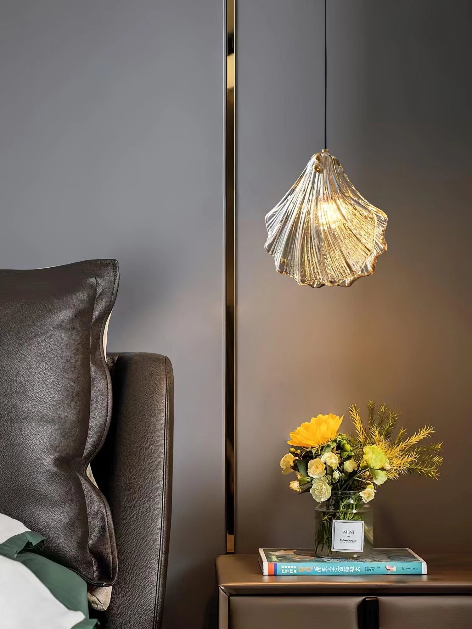 Elegant Petal Glass Pendant Light - Modern LED Floral Chandelier hanging from the ceiling, illuminating a cozy interior with a couch, table, vase, and decorative flowers.