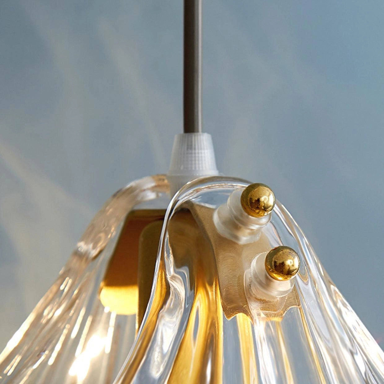 Elegant Petal Glass Pendant Light with Modern LED Floral Design hanging from ceiling in a room with a wooden background.