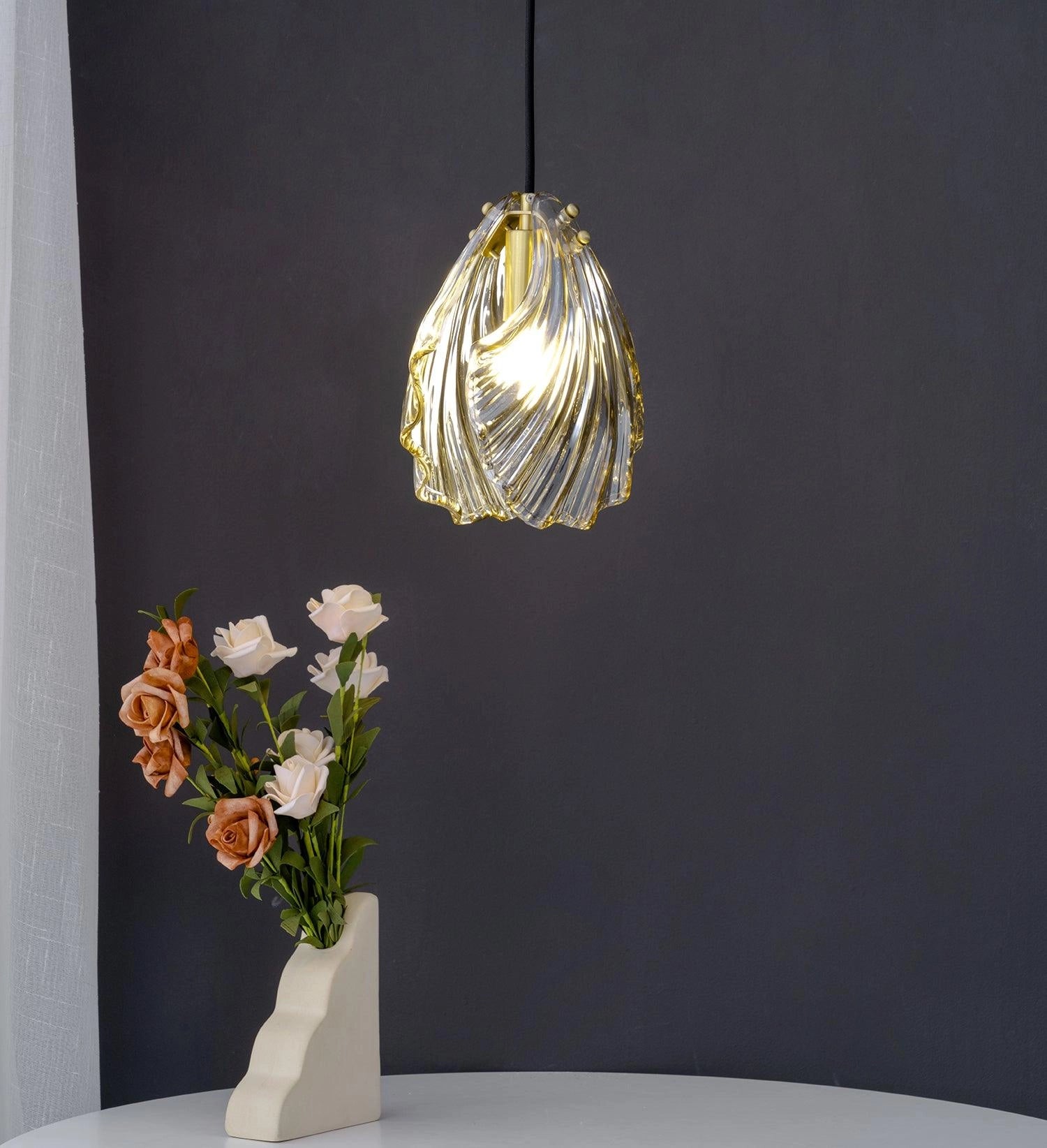 Modern LED floral chandelier in the shape of elegant glass petals, resembling a blooming flower, suspended in a stylish interior.