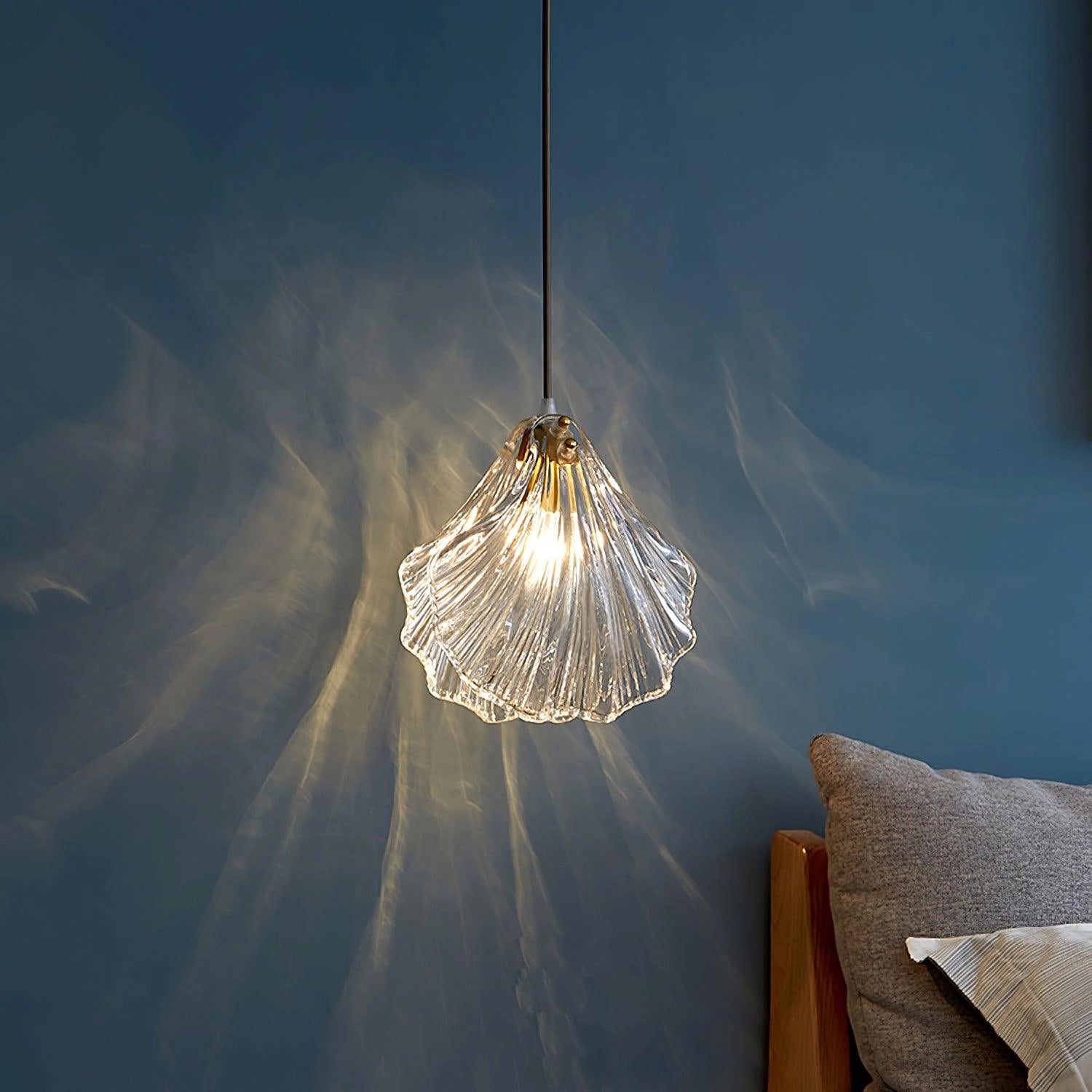 Elegant petal-shaped glass pendant light chandelier with modern LED illumination, featuring a floral design, hanging from a ceiling in a symmetrical arrangement.