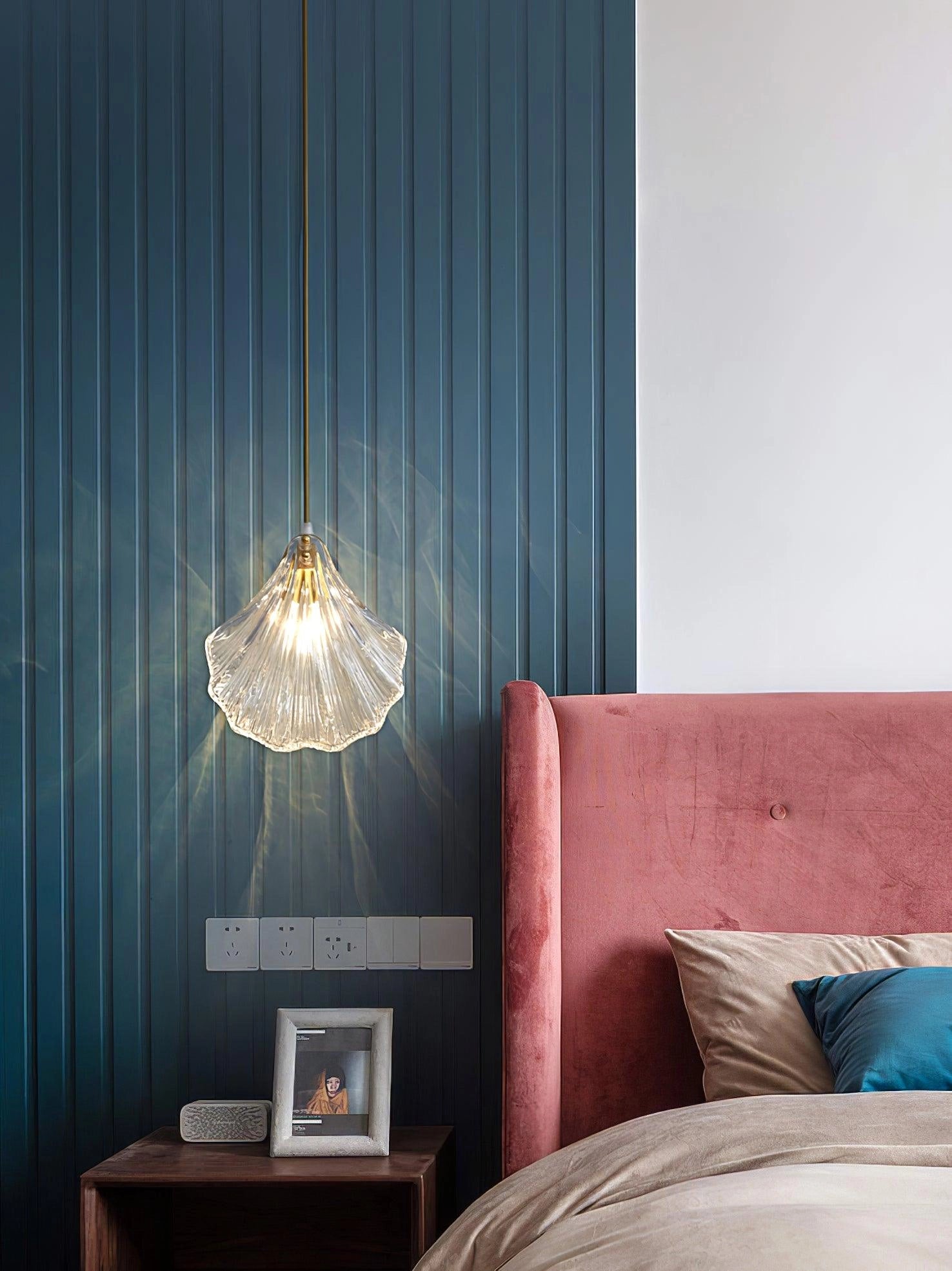 Elegant Petal Glass Pendant Light with modern LED design, featuring a floral chandelier style, hanging in a cozy interior with wood and textile elements.
