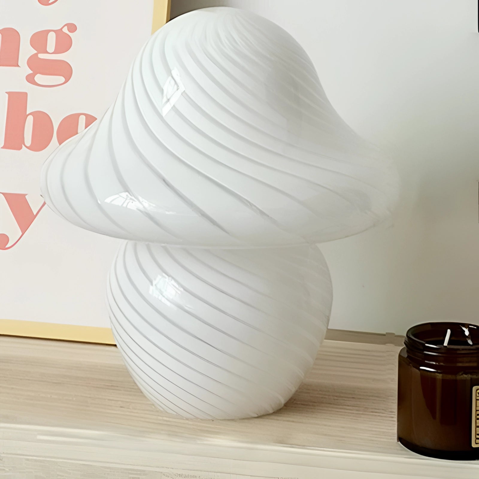 Elegant white spiral table lamp with a modern sculptural design, featuring a large swirl shape that resembles porcelain artwork.