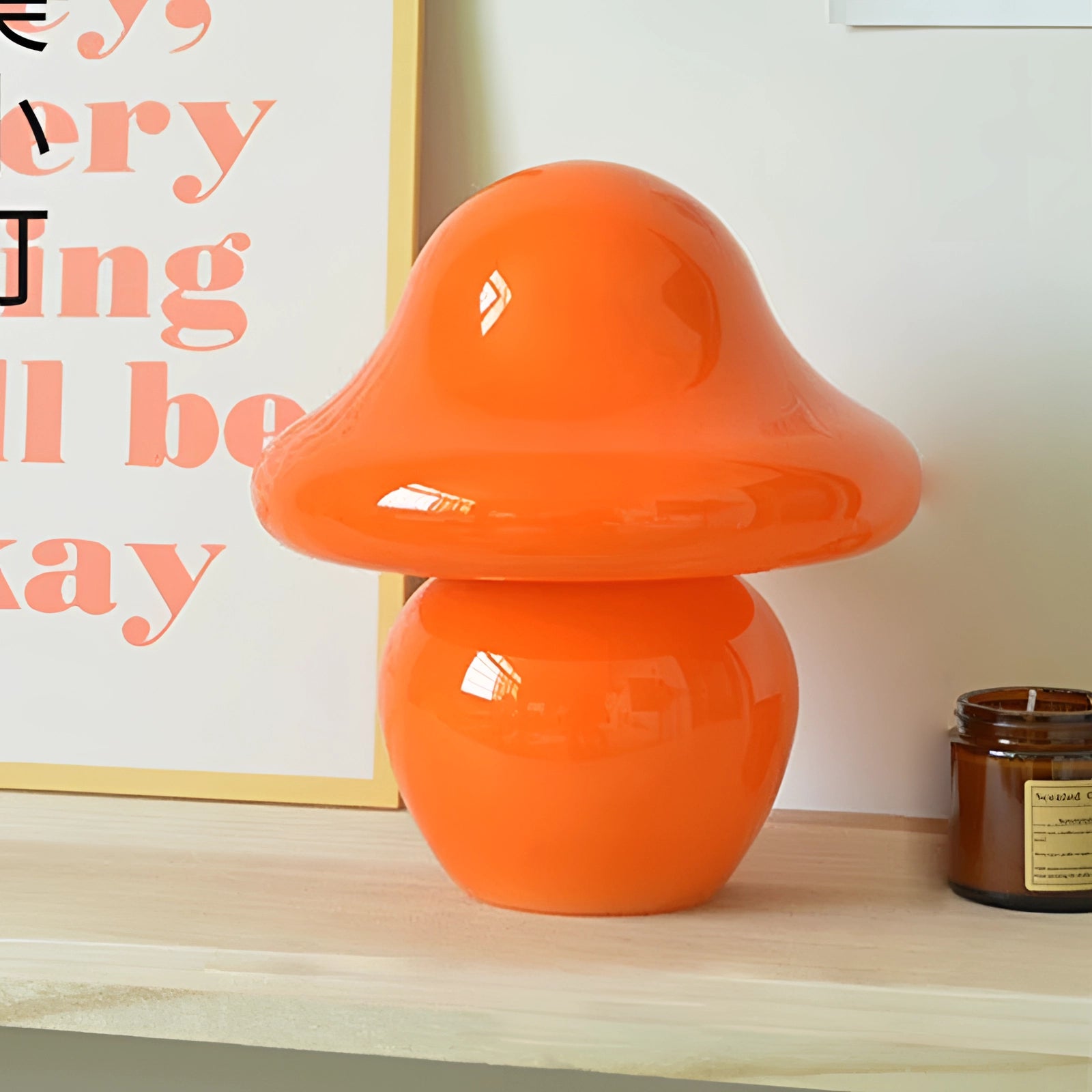 Elegant small spiral table lamp in orange with a modern sculptural design.