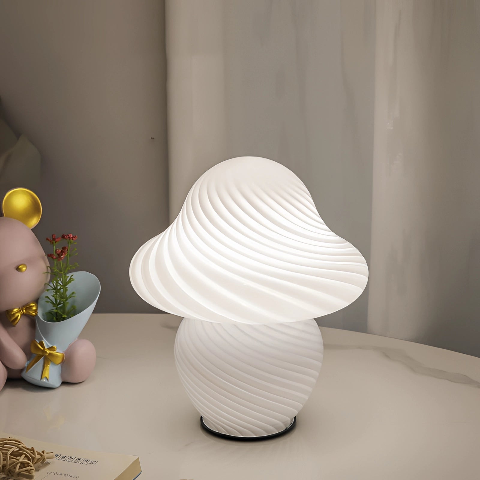 Elegant white spiral table lamp with a modern sculptural design, featuring a small swirl pattern, ideal for contemporary interiors.