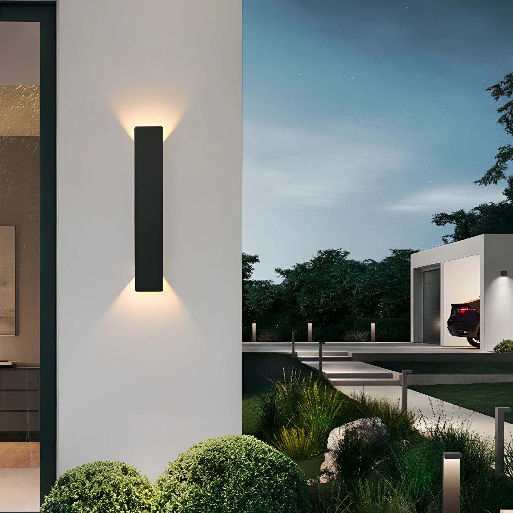 Energy efficient black LED linear light installed outdoors, emitting warm white light in a 24w capacity, blending with a daytime urban setting surrounded by greenery.
