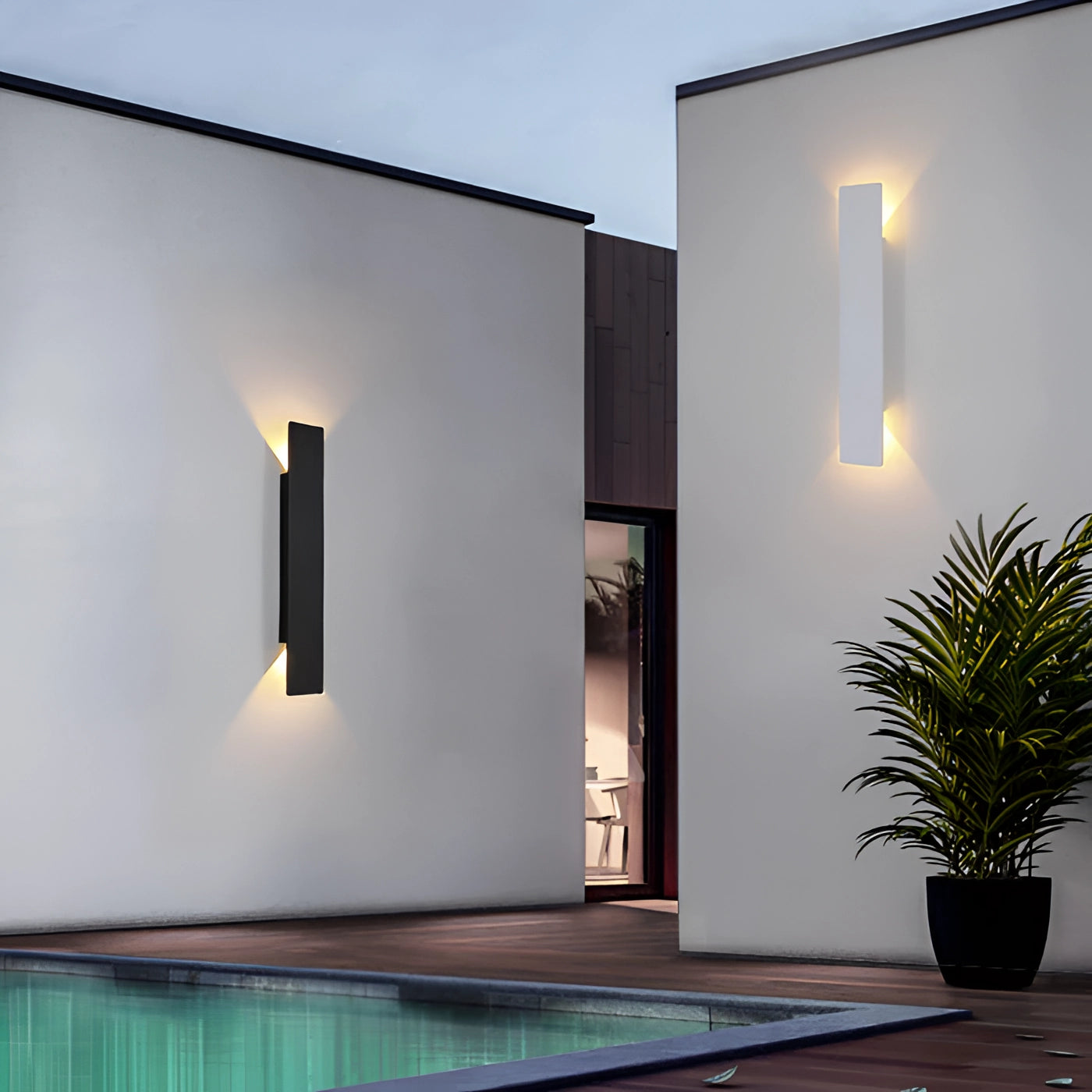 Energy efficient LED linear light illuminating an outdoor area featuring a waterproof design, with white and warm white light options, installed in an exterior setting with plants, flowerpots, and wood elements.