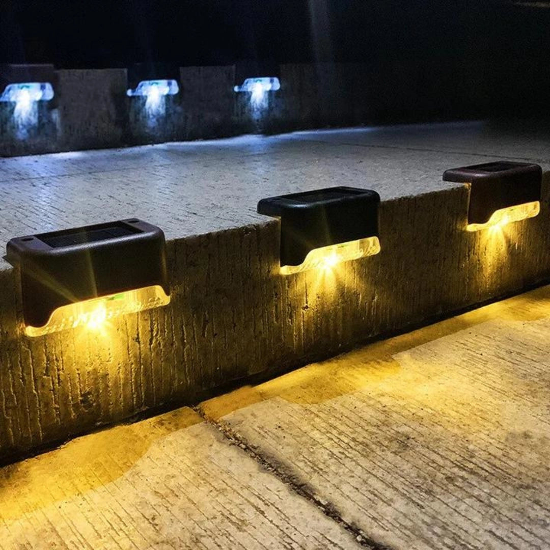 Energy-efficient LED waterproof deck lights installed on a wooden outdoor patio, illuminating the area with a warm glow.