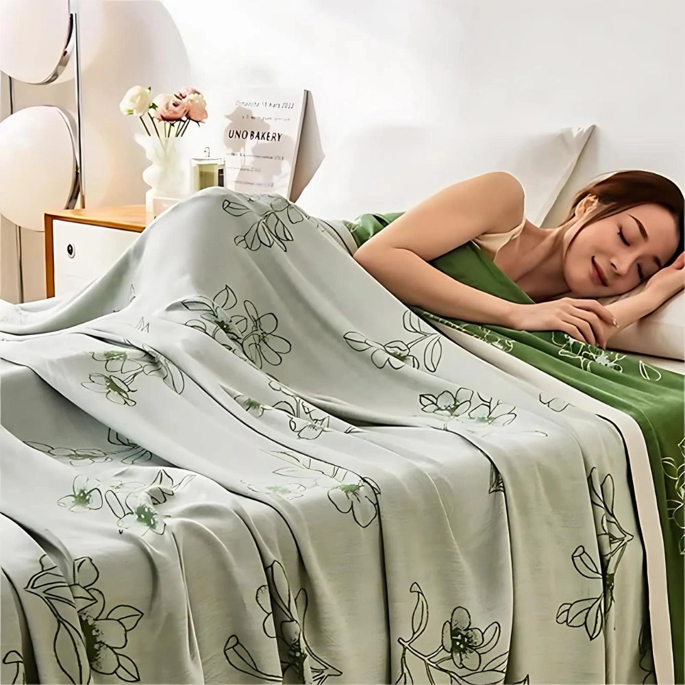 Green botanical luxury duvet cover and satin sheets set with floral patterns, size 200x230cm, elegantly displayed on a bed.