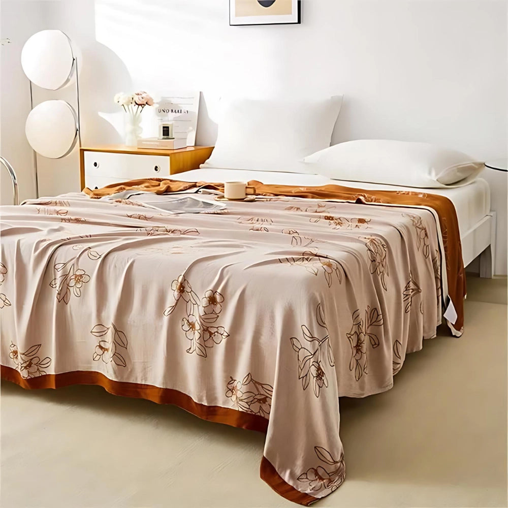Green floral bedding set with botanical patterns displayed on a brown-colored duvet and satin sheets, sized 200x230cm, arranged on a wooden table with a white tablecloth, in a well-designed interior space with hardwood flooring.