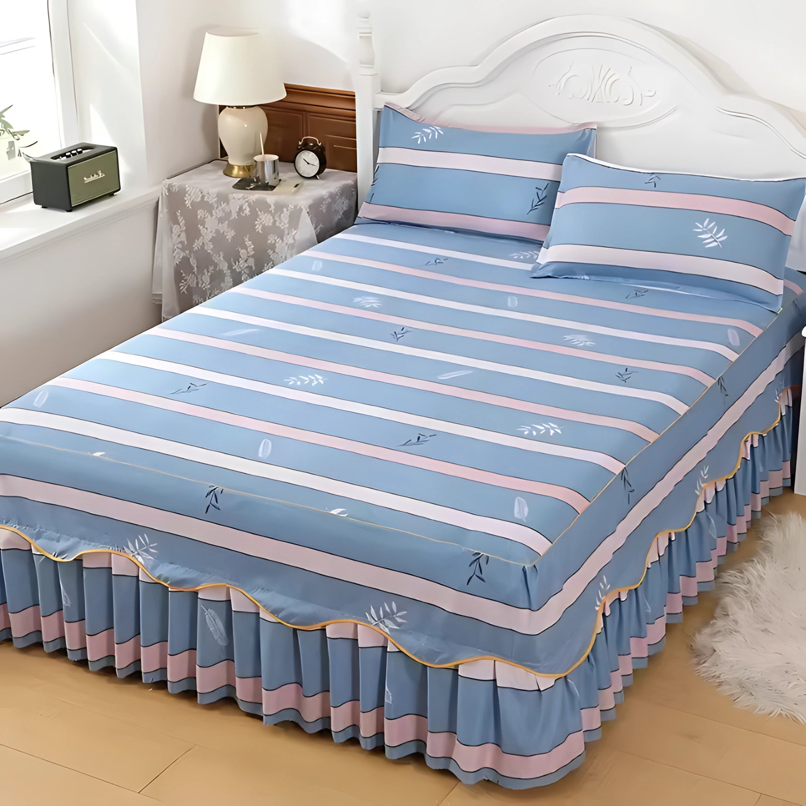 Floral luxury ice silk bedding set featuring a ruffled skirt and matching pillowcase on a bed with a wooden frame in a stylishly designed bedroom.