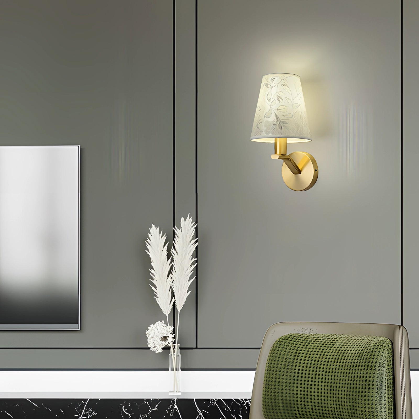 Elegant floral pattern wall sconce with gold accents featuring a rectangular design, casting warm lighting in a bedroom setting with plant and wood elements visible nearby.