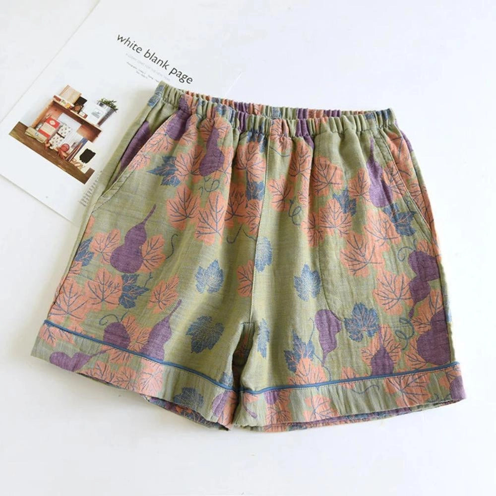 Floral print pants featuring a ginkgo leaf design with an elastic waistband, suitable for casual wear.
