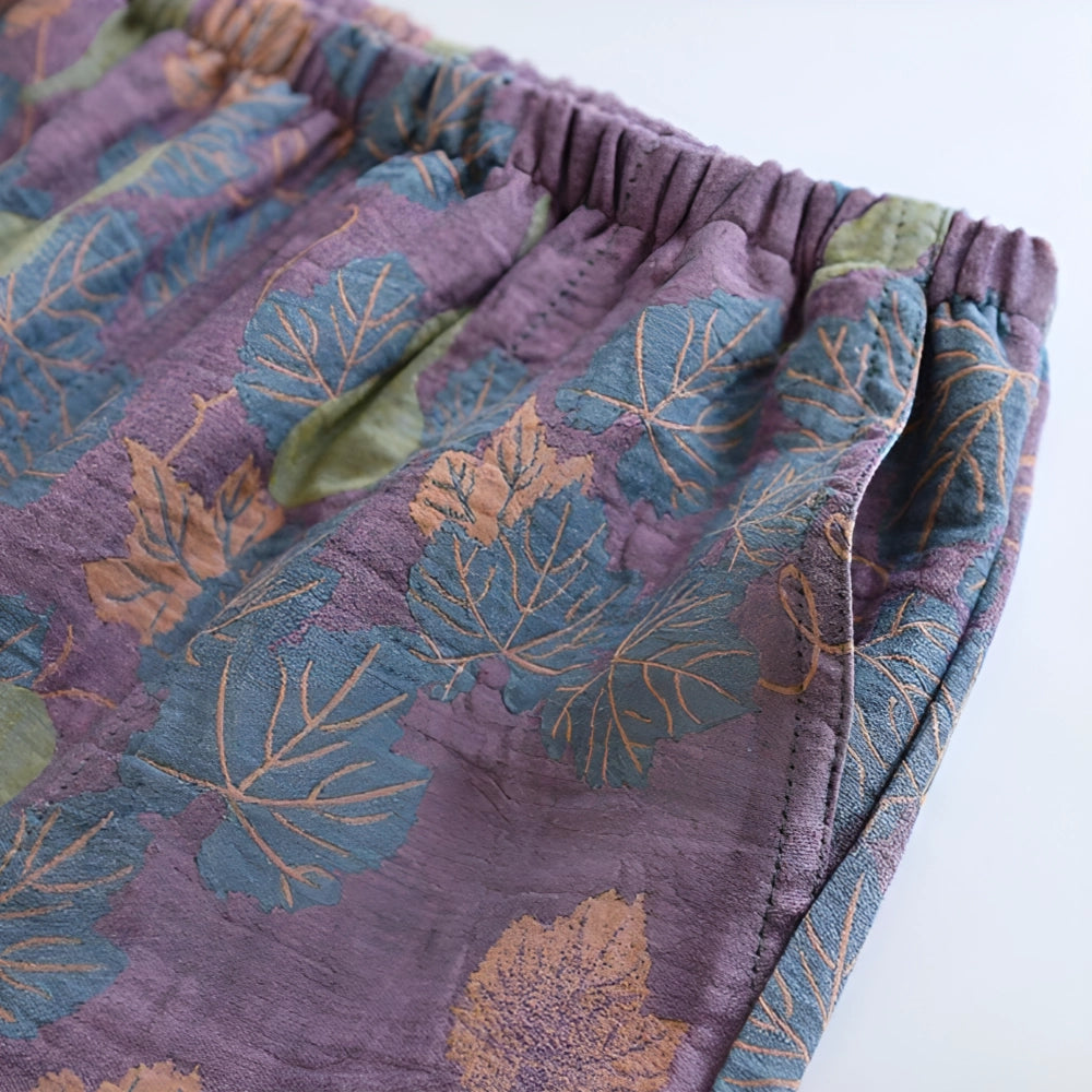 Floral print pants featuring a ginkgo leaf design, showcasing a mix of brown, azure, purple, pink, and violet colors with an elastic waistband.