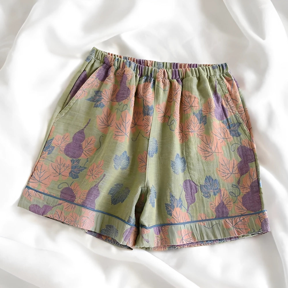 Floral print pants featuring a ginkgo leaf pattern with an elastic waistband, predominantly in shades of pink and magenta.