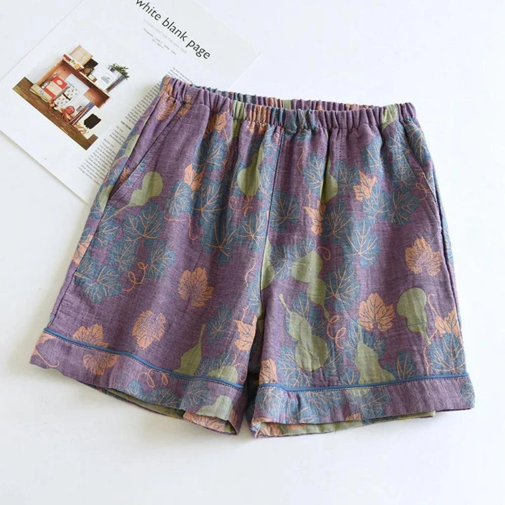 Floral print pants featuring a ginkgo leaf pattern and an elastic waistband, in shades of purple and electric blue.
