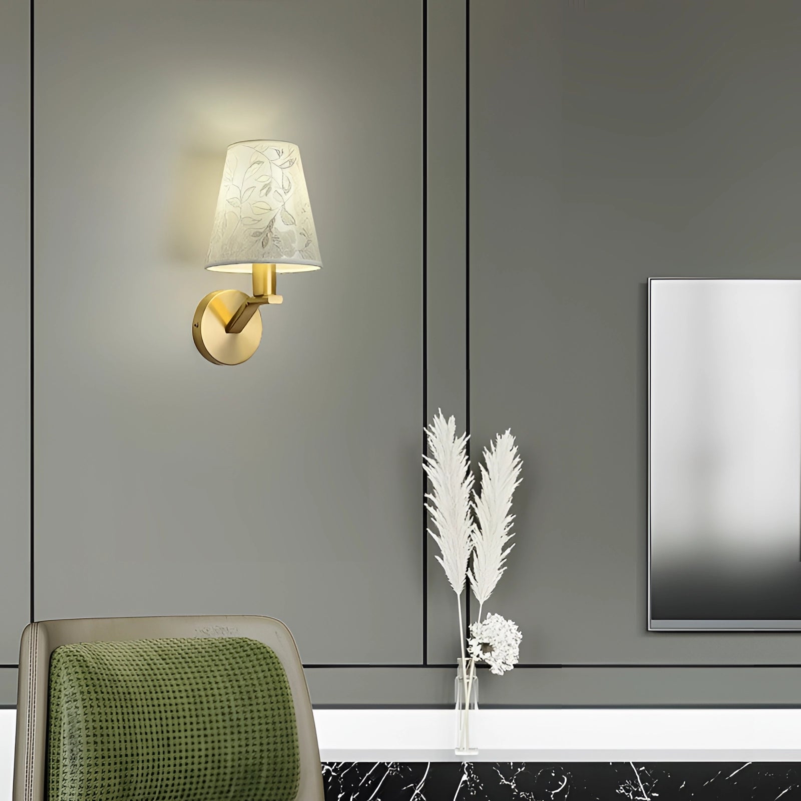 Elegant gold floral wall lamp mounted beside a couch, enhancing the interior design with its artistic sconce decor, and complemented by nearby furniture and a decorative plant.