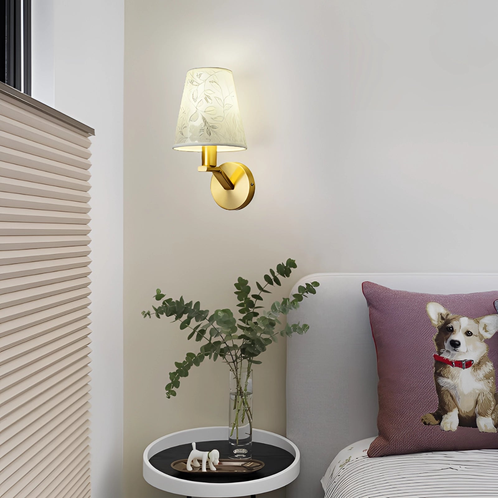 Elegant floral wall lamp with gold sconce, beautifully illuminating a bedside area with green plant decor nearby, enhancing the interior design.